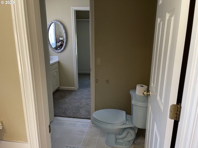 bathroom featuring vanity, toilet, and tile patterned flooring