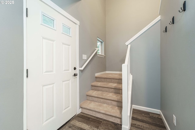 interior space featuring stairway, baseboards, and dark wood finished floors