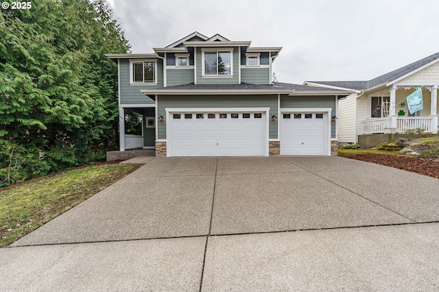 view of front of home featuring stone siding, a porch, concrete driveway, and an attached garage