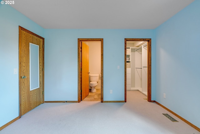 2038 Titan Ter, West Linn, OR 97068 - unfurnished bedroom featuring a walk in closet, carpet, a closet, and connected bathroom