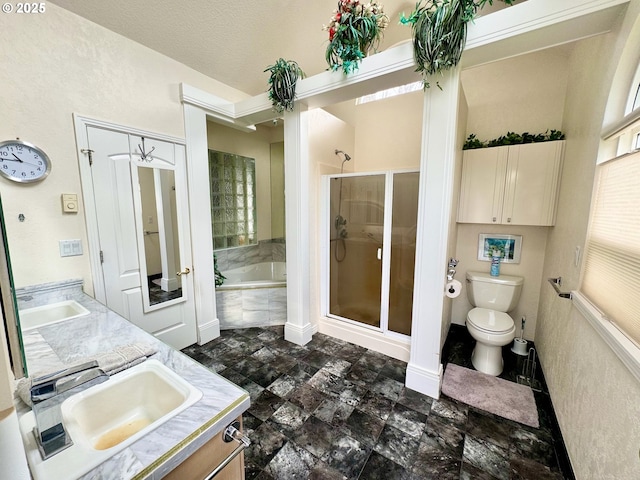 full bathroom featuring vanity, toilet, and separate shower and tub