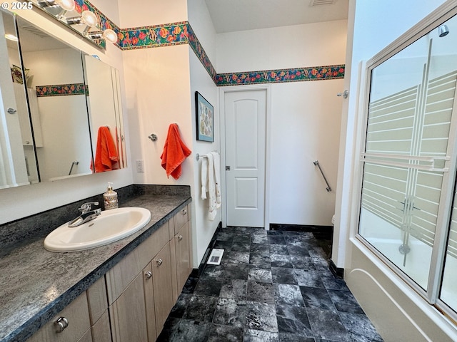 bathroom featuring vanity and combined bath / shower with glass door