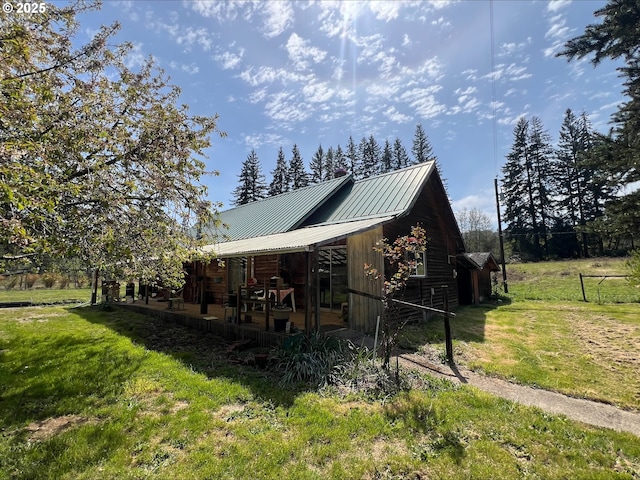 view of home's exterior featuring a lawn and metal roof