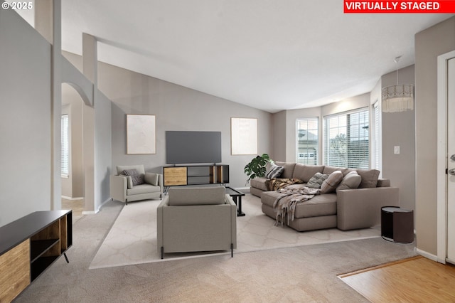 living room featuring vaulted ceiling and light carpet