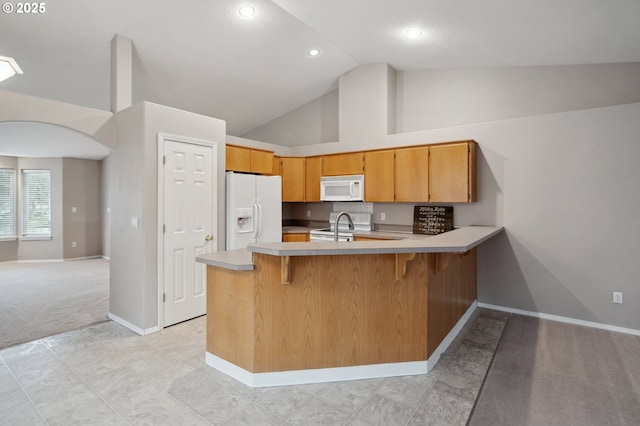 kitchen with high vaulted ceiling, light colored carpet, white appliances, and kitchen peninsula