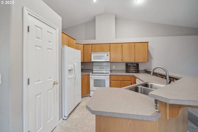 kitchen with sink, white appliances, light tile patterned floors, a kitchen bar, and kitchen peninsula