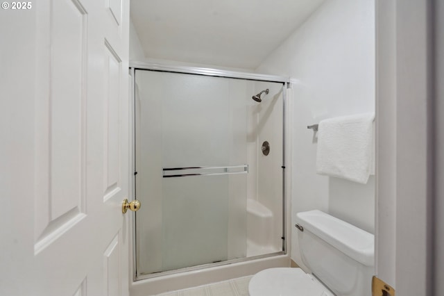 bathroom featuring an enclosed shower and toilet