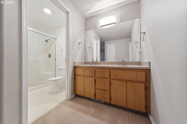 bathroom with an enclosed shower, vanity, and toilet