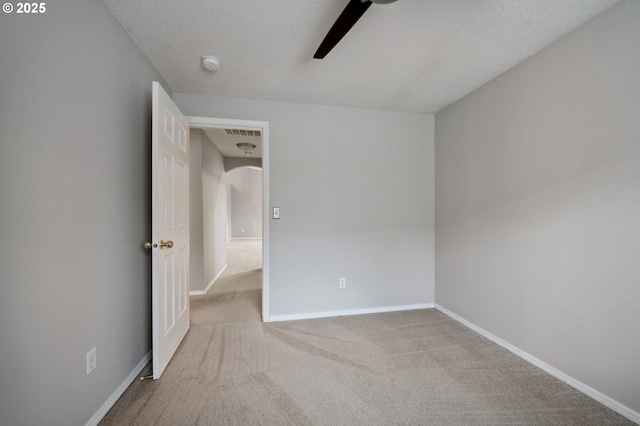 carpeted empty room with a textured ceiling