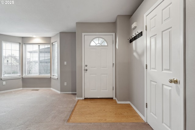 foyer featuring light colored carpet