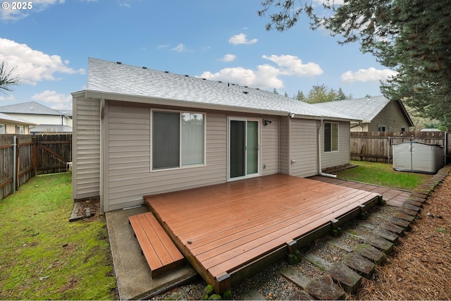 rear view of property with a deck and a lawn