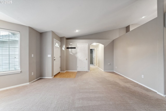 carpeted spare room featuring lofted ceiling