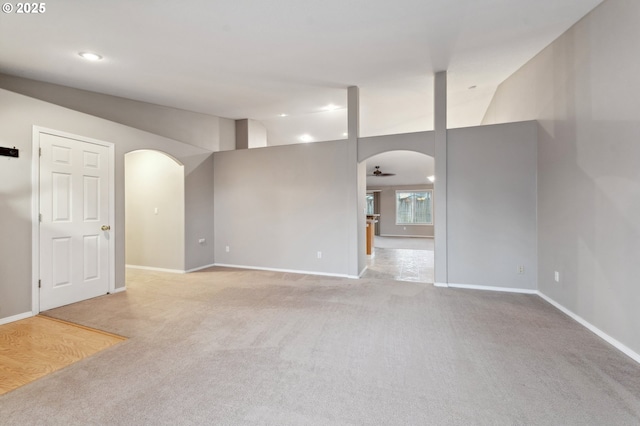 empty room with light colored carpet and ceiling fan