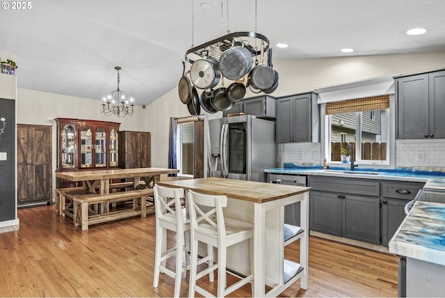 112 Stoneway Ln, Longview, WA 98632 - kitchen featuring butcher block counters, stainless steel fridge, lofted ceiling, a sink, and tasteful backsplash