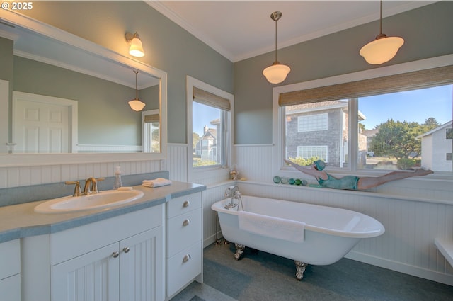 bathroom with vanity, a tub to relax in, and crown molding