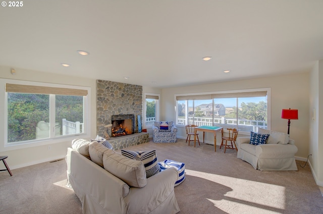 living room featuring light carpet and a fireplace