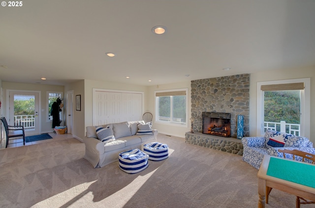 living room featuring a fireplace and light colored carpet