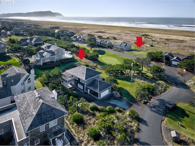 bird's eye view featuring a water view and a view of the beach