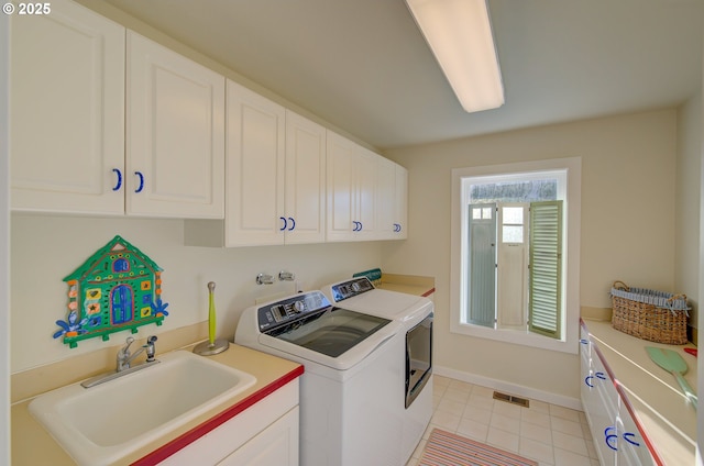 washroom featuring cabinets, separate washer and dryer, and sink