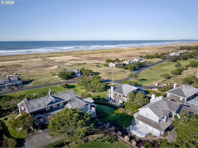 drone / aerial view featuring a water view and a beach view