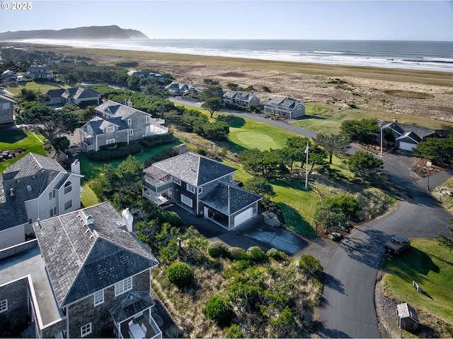 birds eye view of property featuring a water view and a beach view