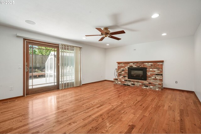 unfurnished living room featuring wood finished floors, a ceiling fan, recessed lighting, a fireplace, and baseboards