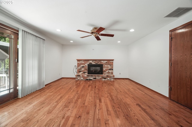 unfurnished living room featuring recessed lighting, a ceiling fan, light wood finished floors, a fireplace, and baseboards