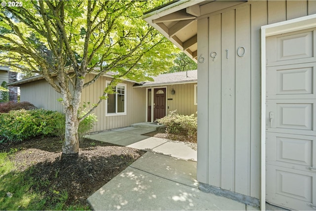 doorway to property with a garage