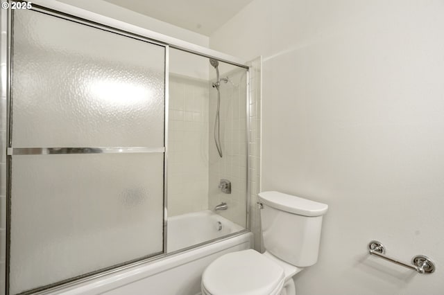 full bath featuring toilet and combined bath / shower with glass door
