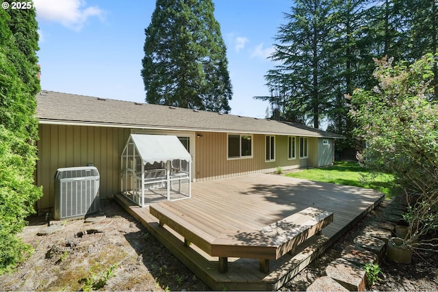 back of house with central AC unit and a wooden deck