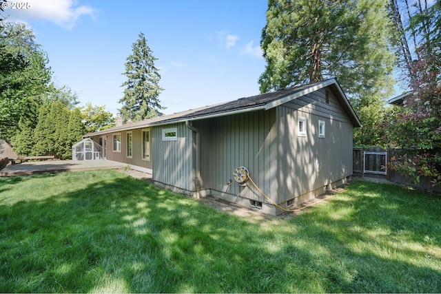 rear view of property featuring an outdoor structure and a shed