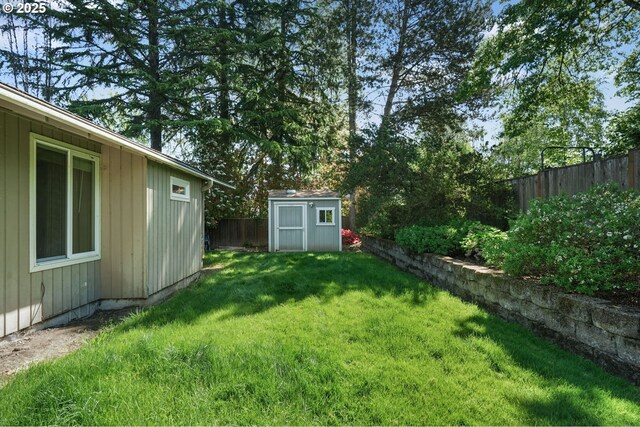 view of yard featuring a storage shed and an outbuilding
