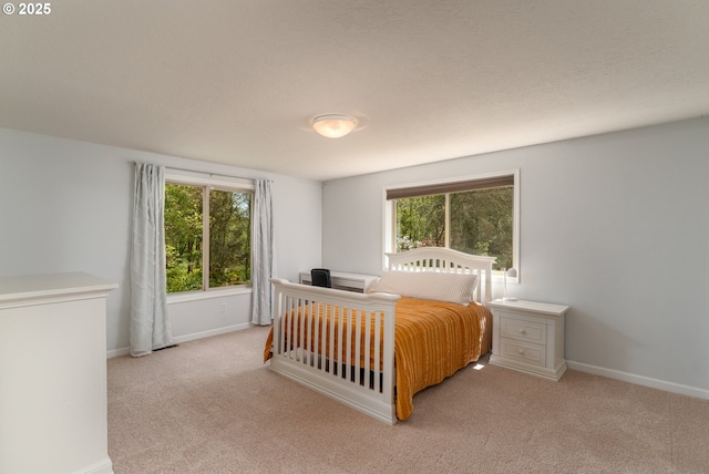 carpeted bedroom with baseboards