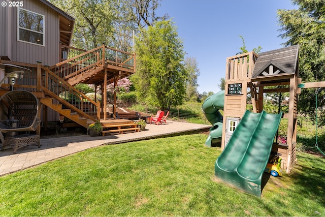 view of jungle gym with a patio, a yard, and a deck