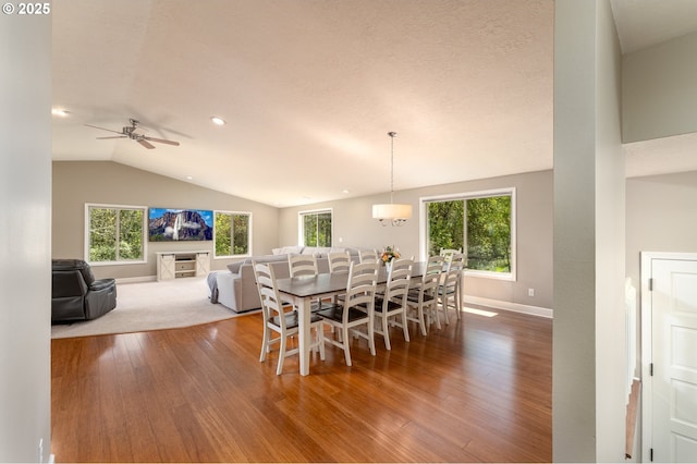 dining area featuring a ceiling fan, vaulted ceiling, wood finished floors, baseboards, and recessed lighting