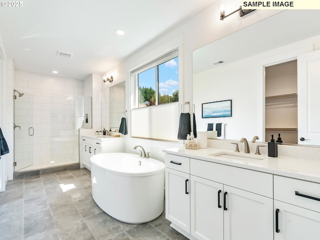 bathroom with plus walk in shower and vanity