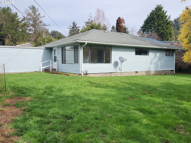 back of property featuring crawl space and a yard