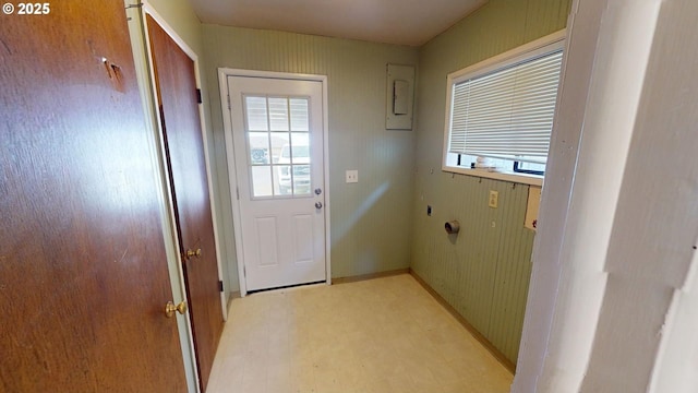 entryway featuring light floors, electric panel, and baseboards