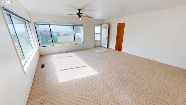 unfurnished room featuring a ceiling fan and visible vents