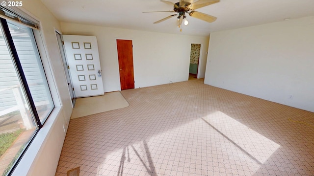 empty room featuring visible vents and ceiling fan