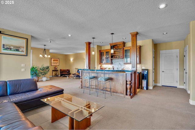 living area with light carpet, recessed lighting, an inviting chandelier, and indoor bar