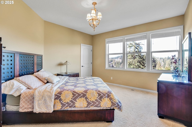 bedroom featuring baseboards, carpet, and a chandelier