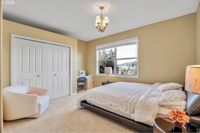 bedroom with a notable chandelier, carpet, and a closet