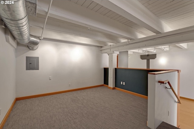 finished basement featuring electric panel, carpet flooring, and baseboards