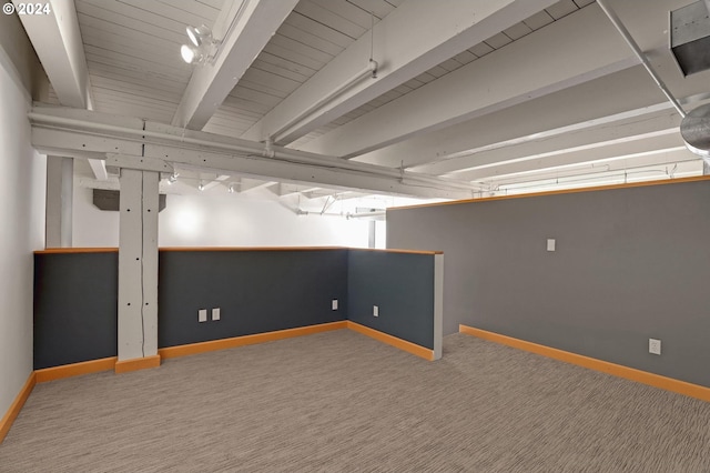 below grade area featuring baseboards and carpet flooring