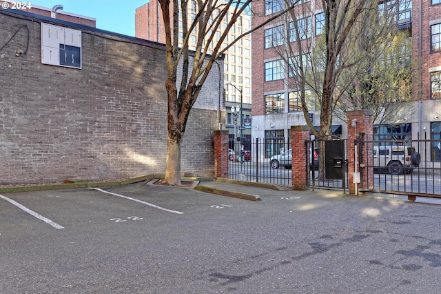 view of property with fence and uncovered parking