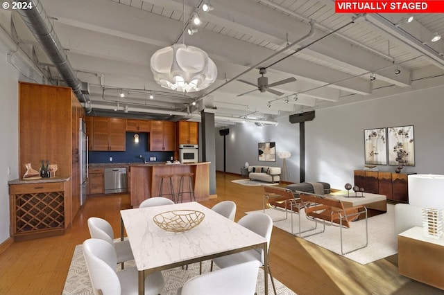 dining space featuring track lighting, light wood-style flooring, and ceiling fan