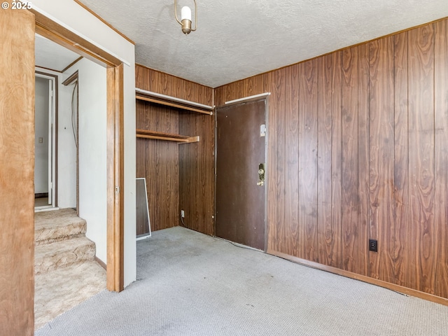 660 Barton Ave, Gladstone, OR 97027 - unfurnished bedroom featuring carpet floors, wood walls, a closet, and a textured ceiling