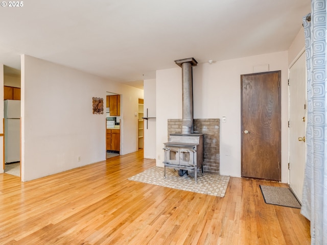 660 Barton Ave, Gladstone, OR 97027 - living area featuring light wood-style flooring and a wood stove