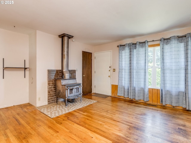 660 Barton Ave, Gladstone, OR 97027 - unfurnished living room with wood finished floors and a wood stove
